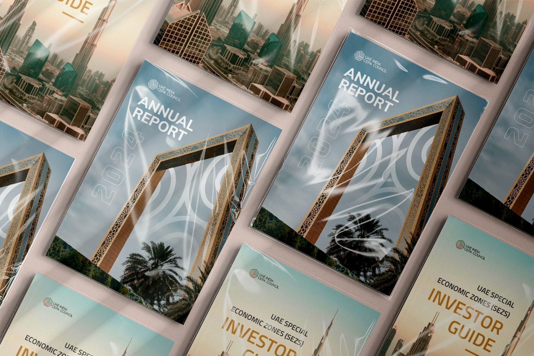 Printed report covers laid out in rows: an Annual Report with the Dubai Frame on the cover, and a UAE Special Economic Zones (SEZs) Investor Guide with a city skyline.