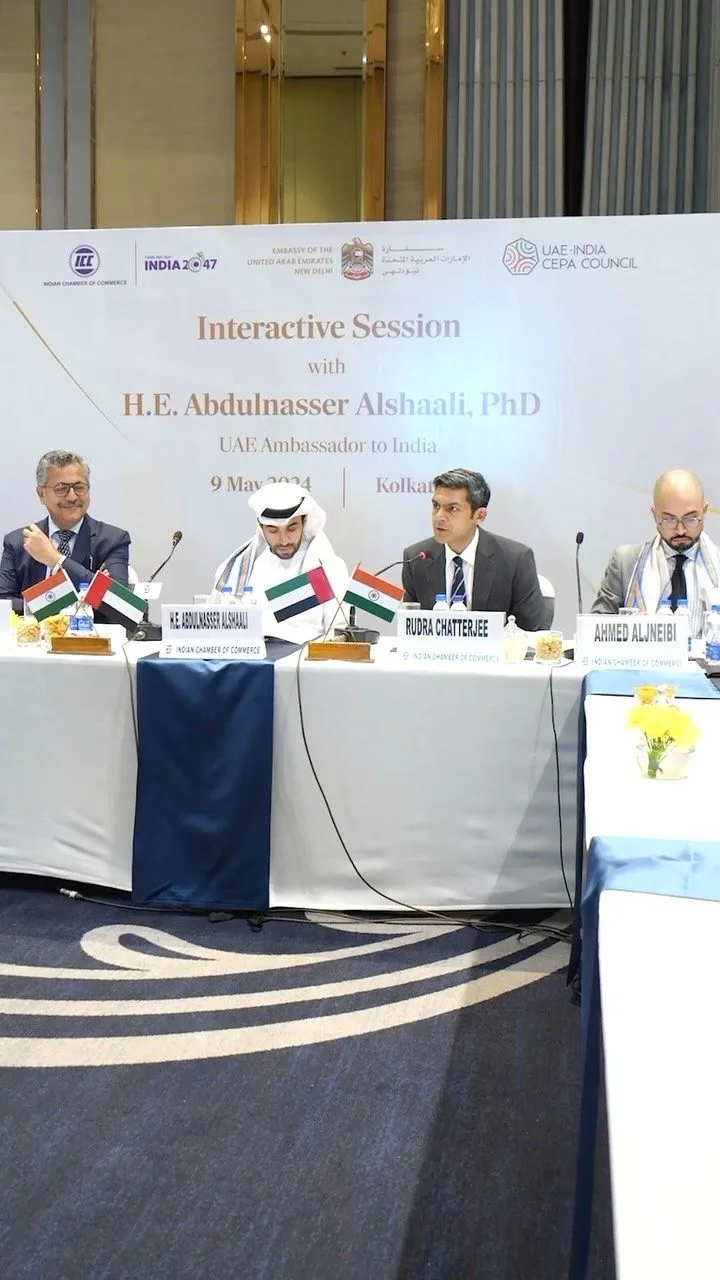 Reel cover: a panel of speakers seated at a table with small flags, in front of an event banner reading “Interactive Session”.