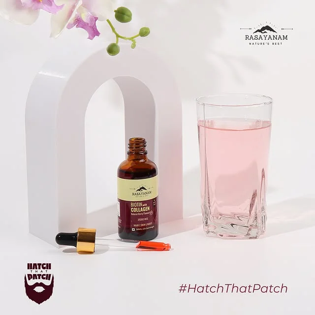 The dropper bottle and a glass of pink drink under a white arch, with orchids and the #HatchThatPatch tag.